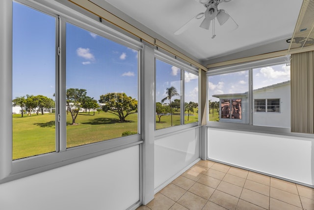 unfurnished sunroom featuring ceiling fan