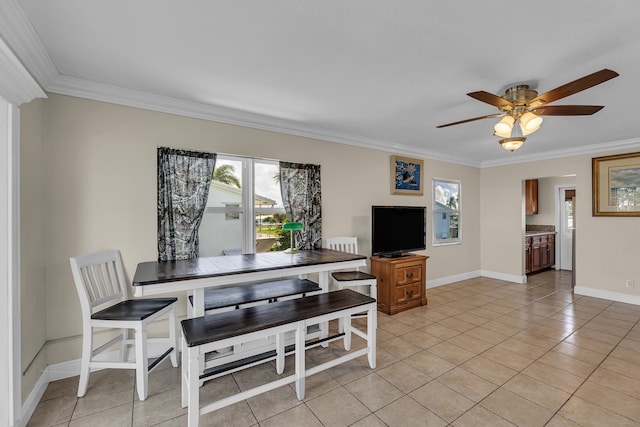 tiled dining space featuring ceiling fan and ornamental molding