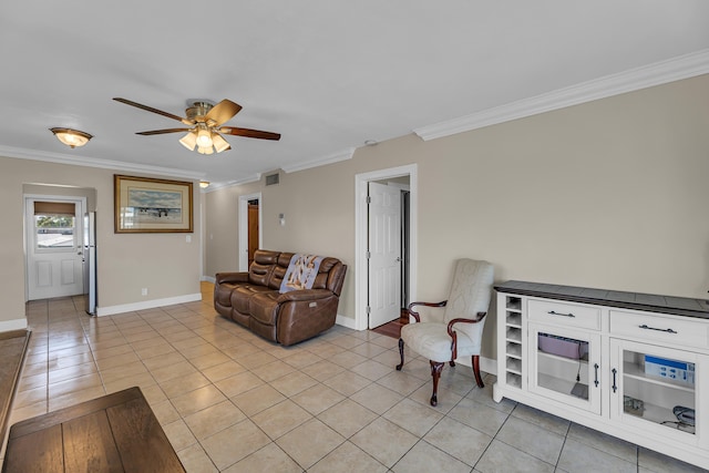 sitting room featuring ceiling fan, light tile patterned flooring, and ornamental molding