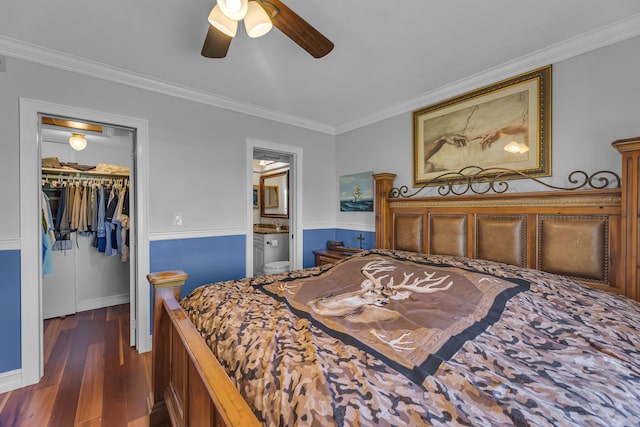 bedroom with a walk in closet, ensuite bath, ceiling fan, ornamental molding, and a closet