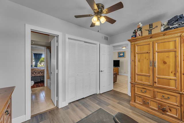 bedroom with ceiling fan, a closet, and light wood-type flooring