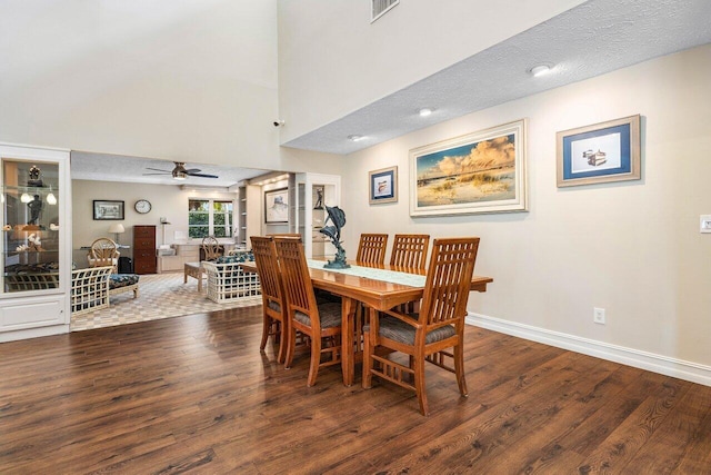 dining space featuring visible vents, a textured ceiling, wood finished floors, baseboards, and ceiling fan