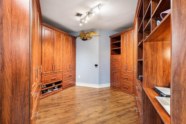 spacious closet featuring visible vents and wood finished floors