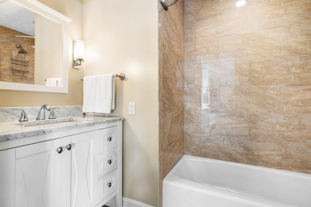 bathroom featuring vanity and  shower combination