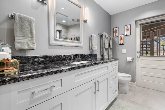 full bathroom with visible vents, toilet, and vanity