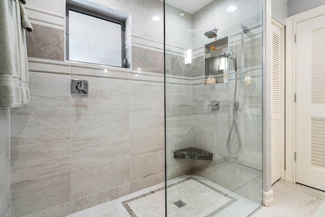 full bathroom with a walk in shower and a closet