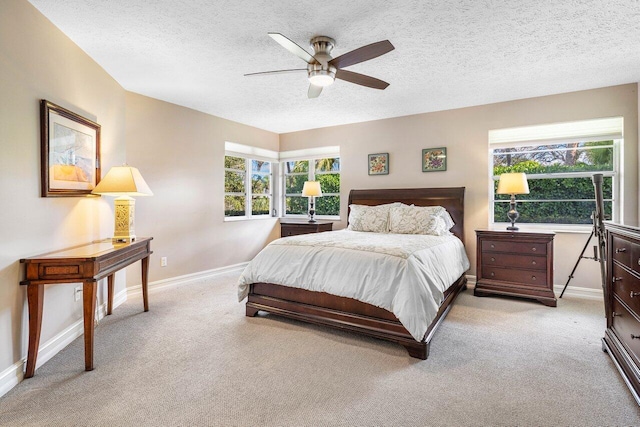 bedroom with a textured ceiling, baseboards, and carpet