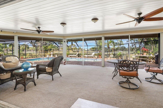 sunroom / solarium featuring a ceiling fan