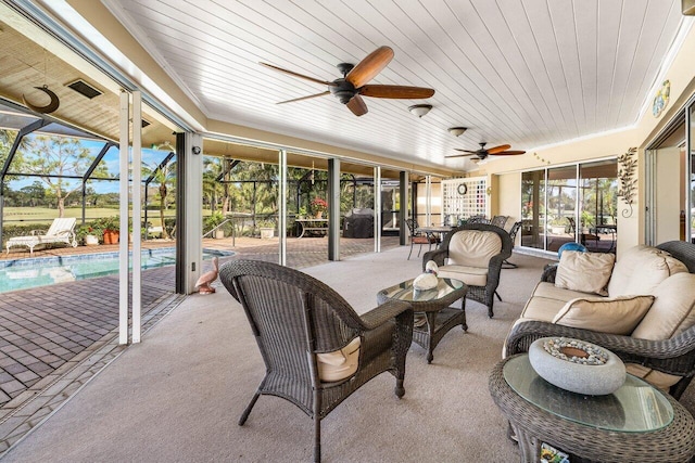 view of patio / terrace featuring an outdoor pool, a lanai, outdoor lounge area, and ceiling fan