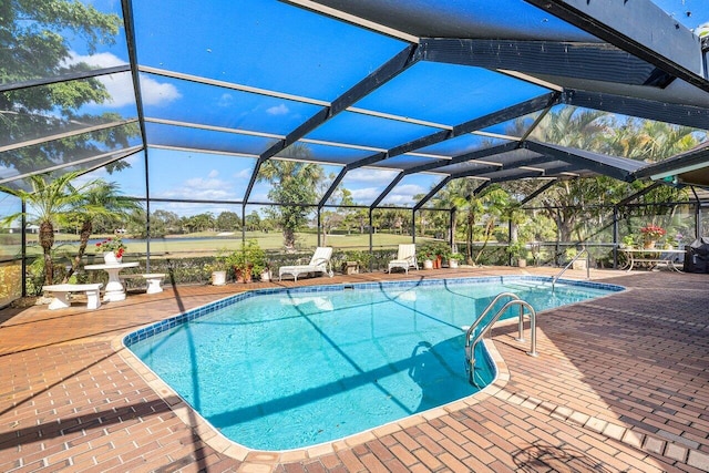 pool featuring glass enclosure and a patio