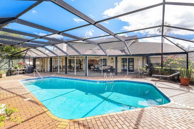 pool with glass enclosure and a patio area