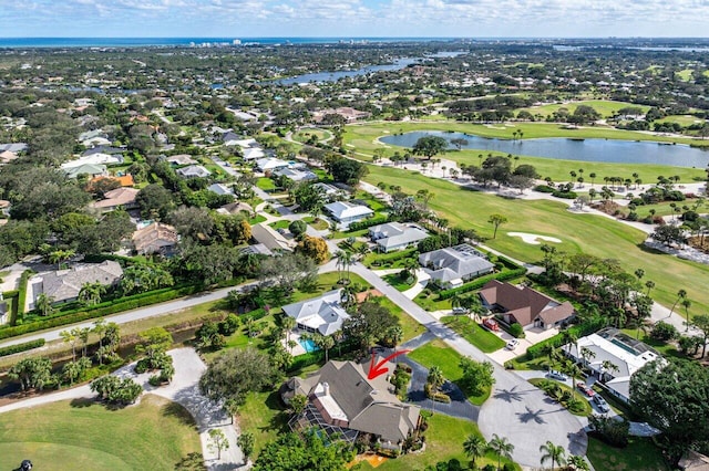 bird's eye view with golf course view, a water view, and a residential view