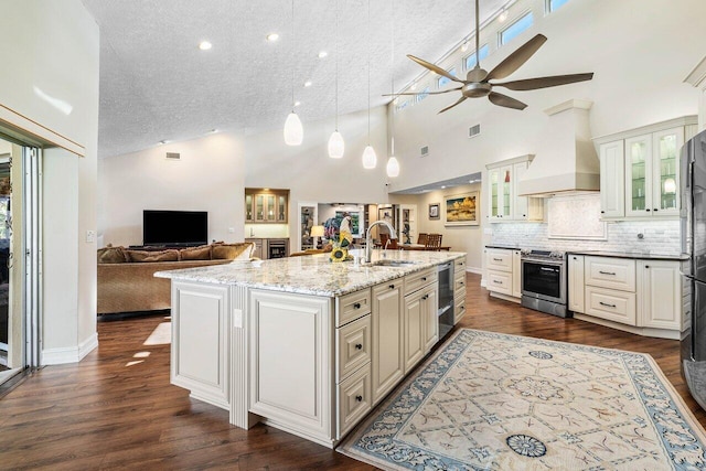 kitchen featuring premium range hood, open floor plan, stainless steel electric range, dark wood-style floors, and a sink