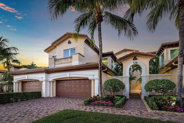 mediterranean / spanish house with a balcony and a garage