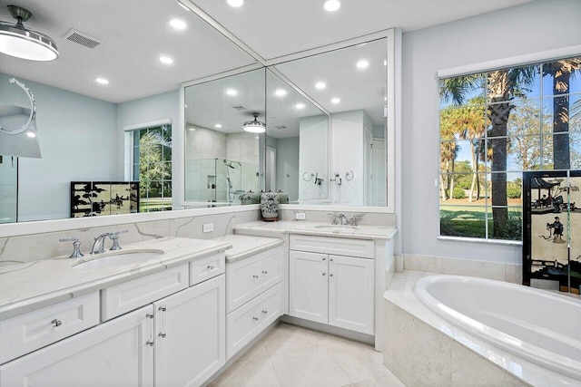 bathroom featuring tile patterned flooring, plenty of natural light, vanity, and independent shower and bath