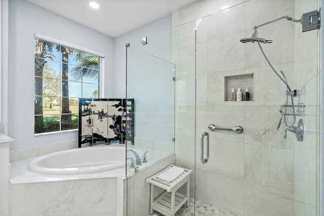 bathroom with separate shower and tub