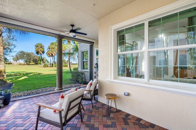 sunroom featuring ceiling fan