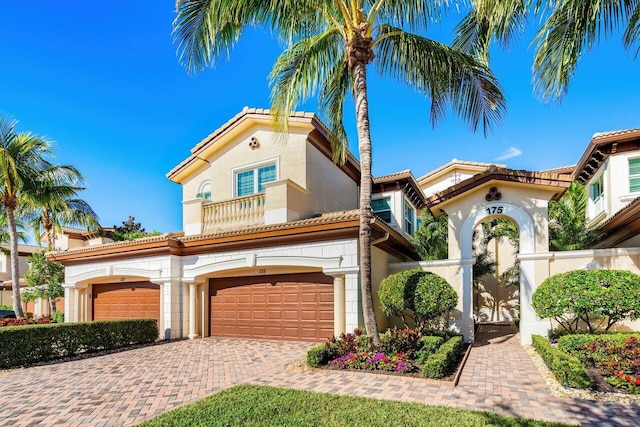 mediterranean / spanish-style house with a garage