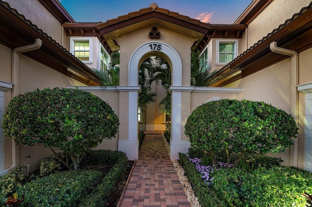 view of exterior entry at dusk