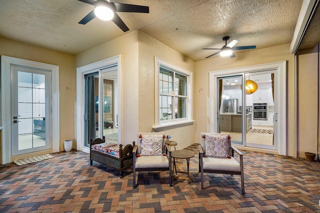 sunroom with ceiling fan