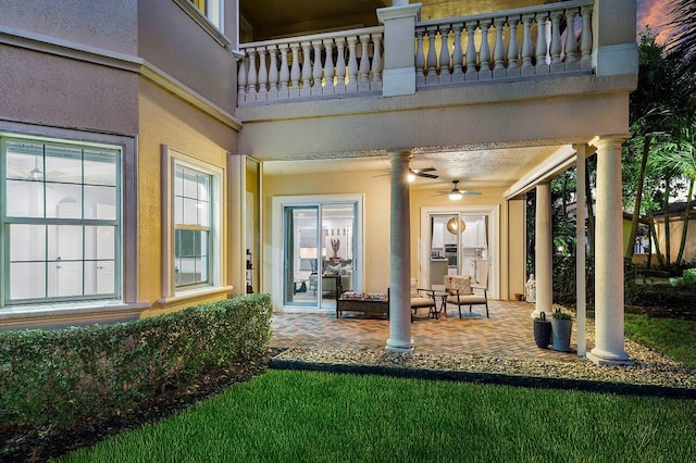 view of patio featuring a balcony and ceiling fan