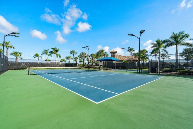 view of tennis court featuring basketball hoop