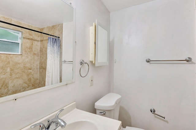 bathroom with sink, toilet, and walk in shower