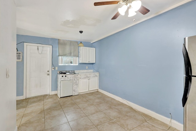 kitchen with white cabinets, light tile patterned floors, white stove, and hanging light fixtures