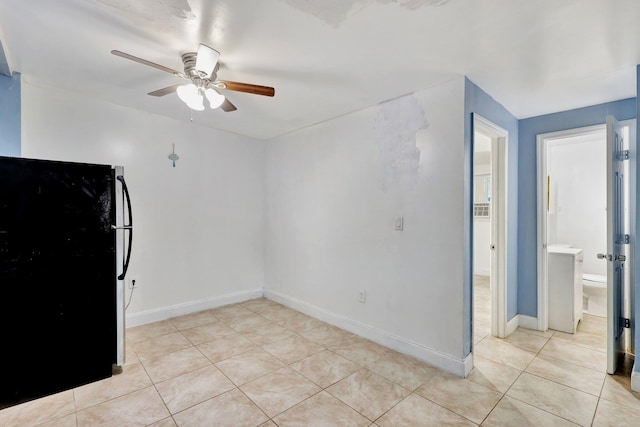 empty room featuring ceiling fan and light tile patterned floors