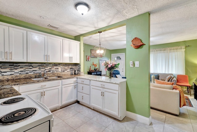 kitchen with white cabinetry, sink, hanging light fixtures, electric range oven, and backsplash