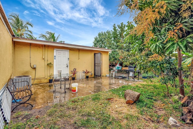 view of yard with central air condition unit and a patio