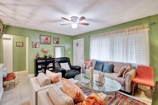 tiled living room with a textured ceiling and ceiling fan