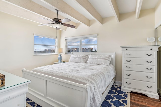 bedroom featuring ceiling fan and beamed ceiling