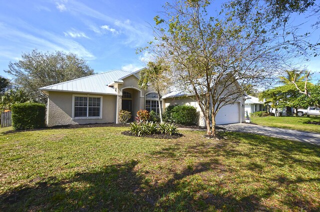 ranch-style home featuring a garage and a front yard