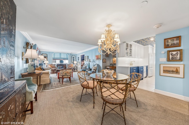 dining room featuring crown molding, light colored carpet, and an inviting chandelier