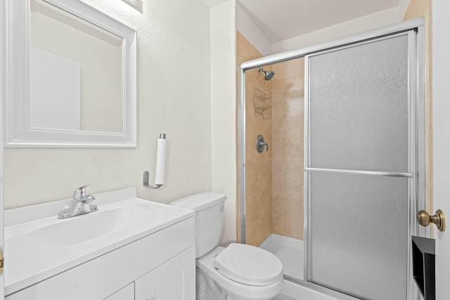 bathroom featuring vanity, toilet, and walk in shower