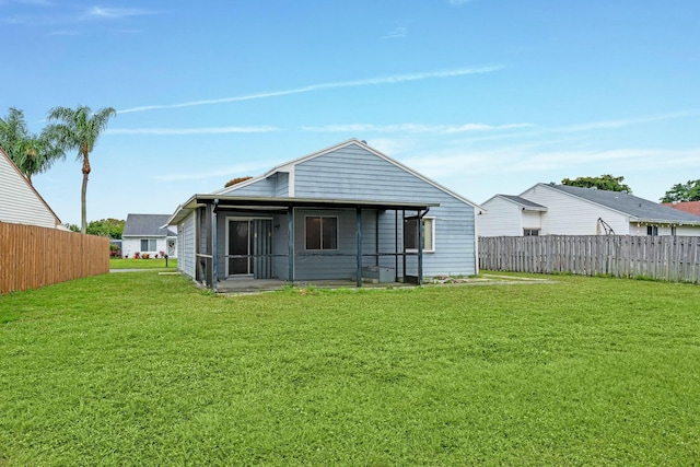 back of house featuring a lawn