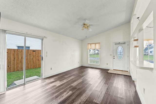 foyer with ceiling fan, wood-type flooring, lofted ceiling, and a wealth of natural light