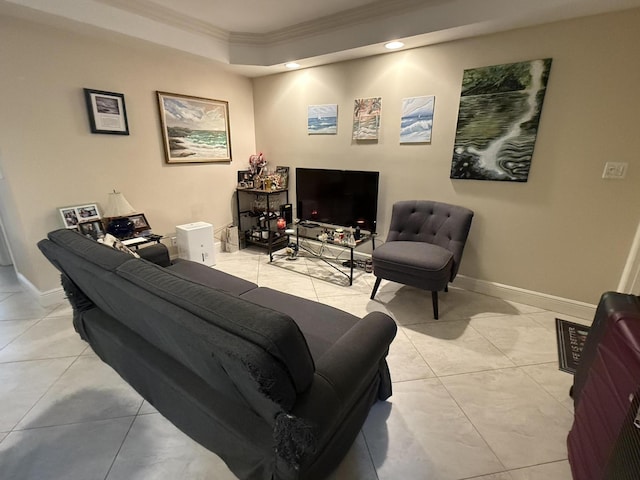 tiled living room with a raised ceiling and ornamental molding