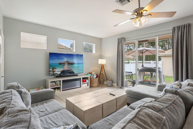 tiled living room with ceiling fan