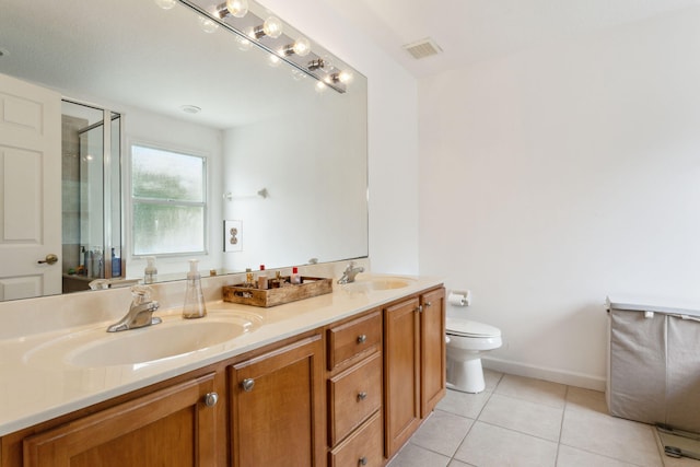 bathroom with toilet, tile patterned flooring, a shower with shower door, and vanity