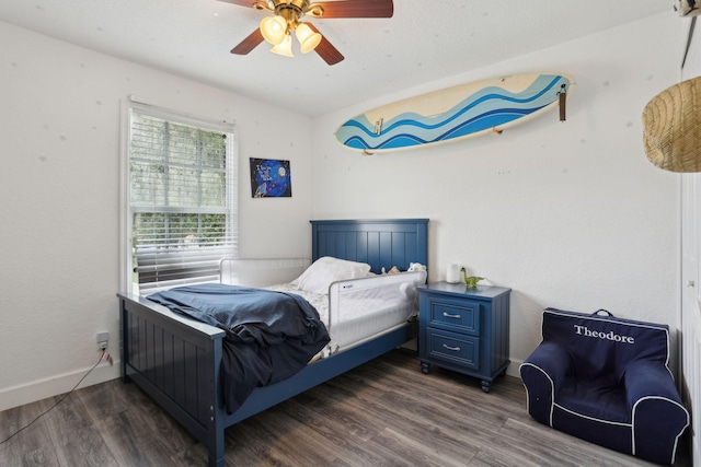 bedroom featuring ceiling fan and dark wood-type flooring