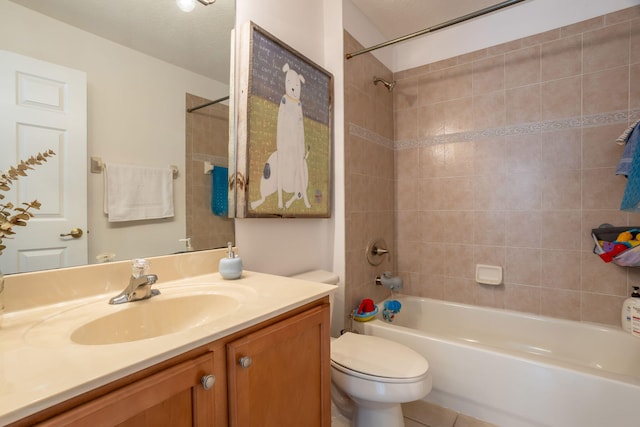 full bathroom with toilet, tile patterned flooring, tiled shower / bath, and vanity