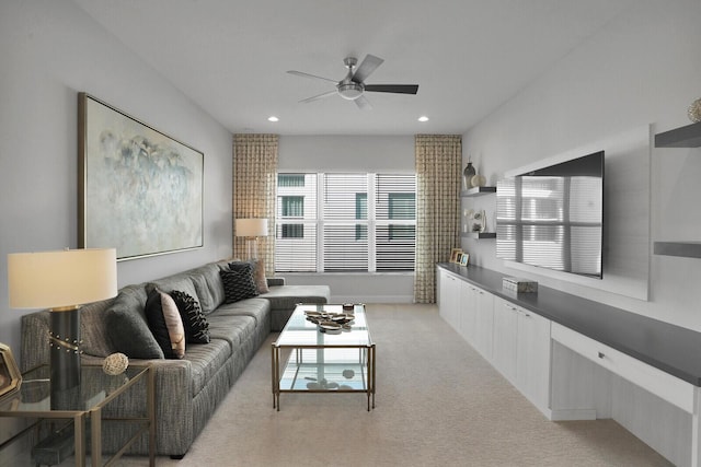 carpeted living room featuring ceiling fan