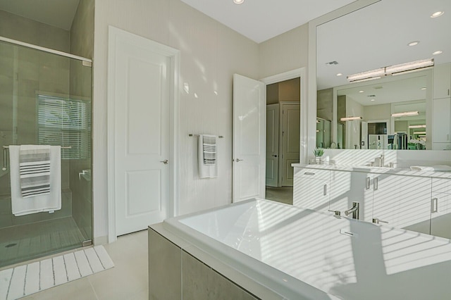 bathroom with tile patterned flooring, vanity, and shower with separate bathtub