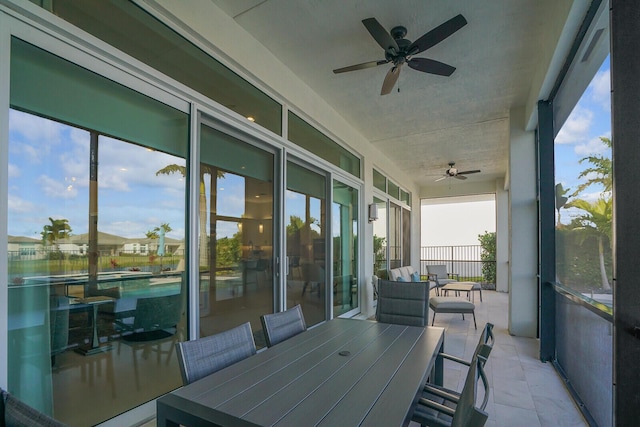 sunroom / solarium featuring ceiling fan