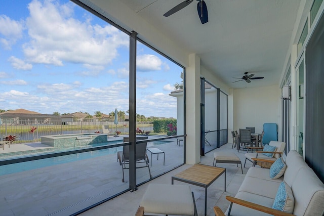 sunroom / solarium featuring a pool and ceiling fan