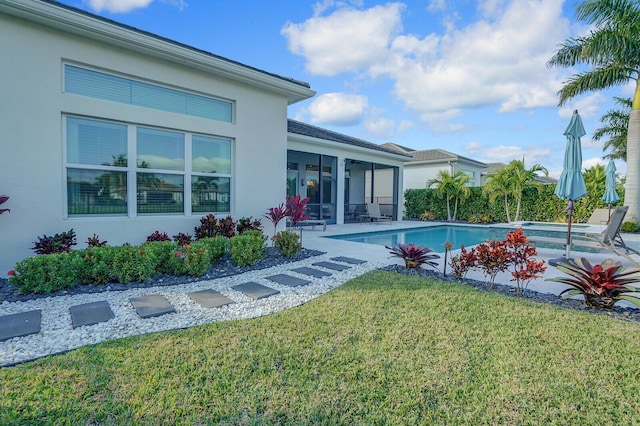 view of swimming pool featuring a patio area and a lawn