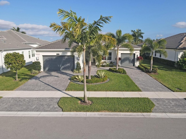 view of front of home featuring a front yard and a garage