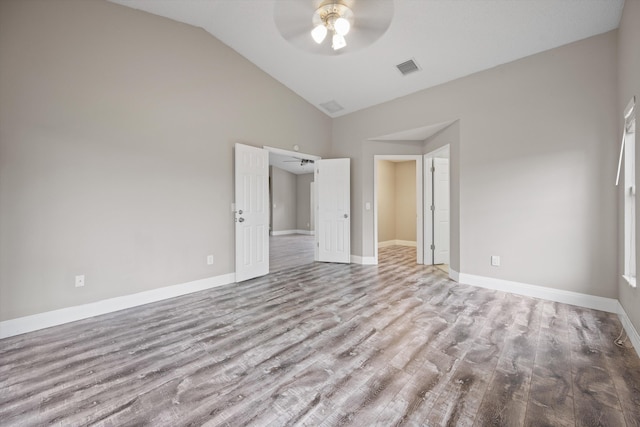 unfurnished bedroom featuring ceiling fan, light hardwood / wood-style flooring, and vaulted ceiling